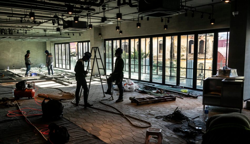 construction industry workers working inside modern building site in ho chi minh city vietnam