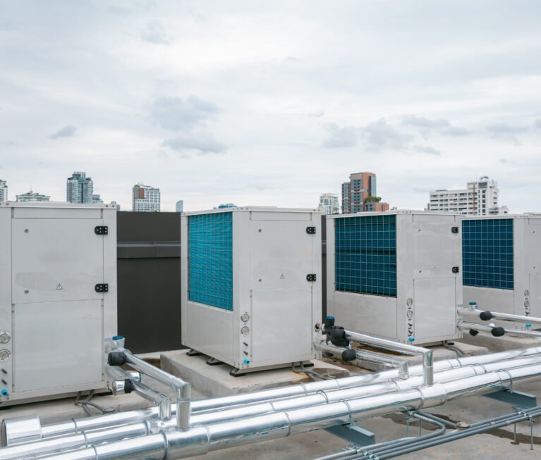 Air conditioner compressor installed in old building. Outdoor split wall type air conditioner compressor unit inverter installed on the outside of the building. Air conditioner compressor outdoor unit