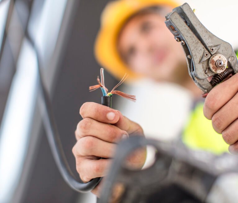 Close-up of electrician working with wire cutter