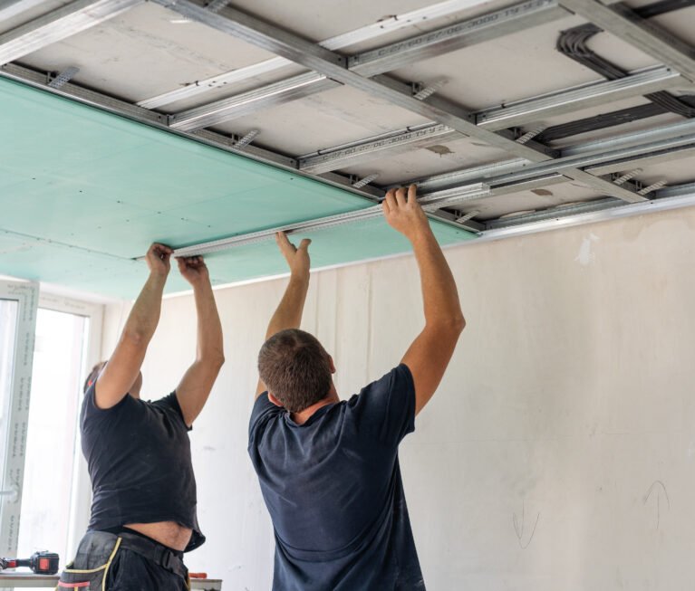 Construction worker ceiling work installation. High quality photo