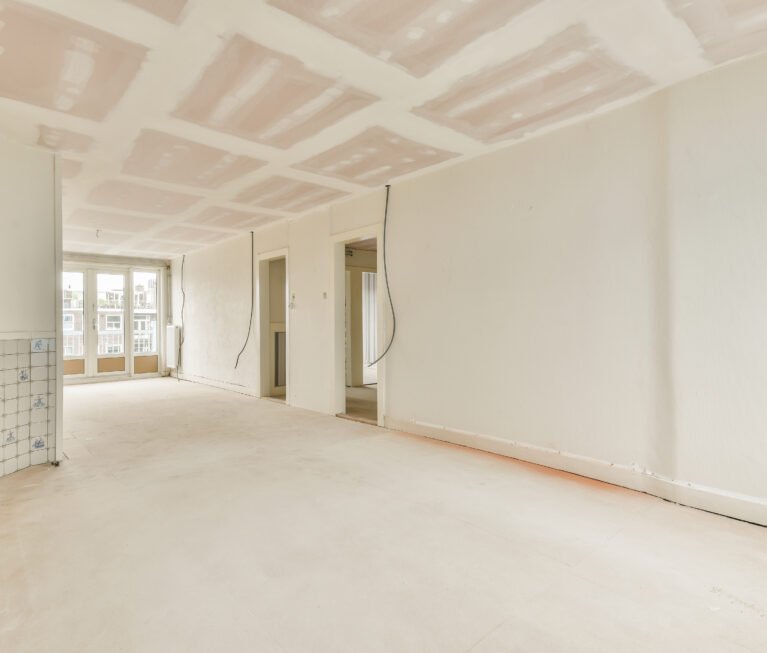 Empty room with windows and radiator in daylight