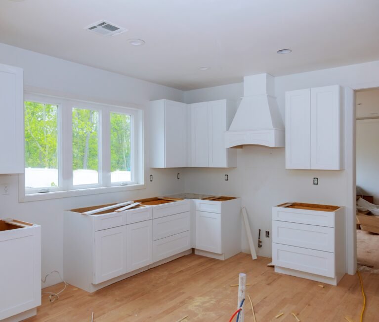 Interior design construction of kitchen with cabinet maker installing custom