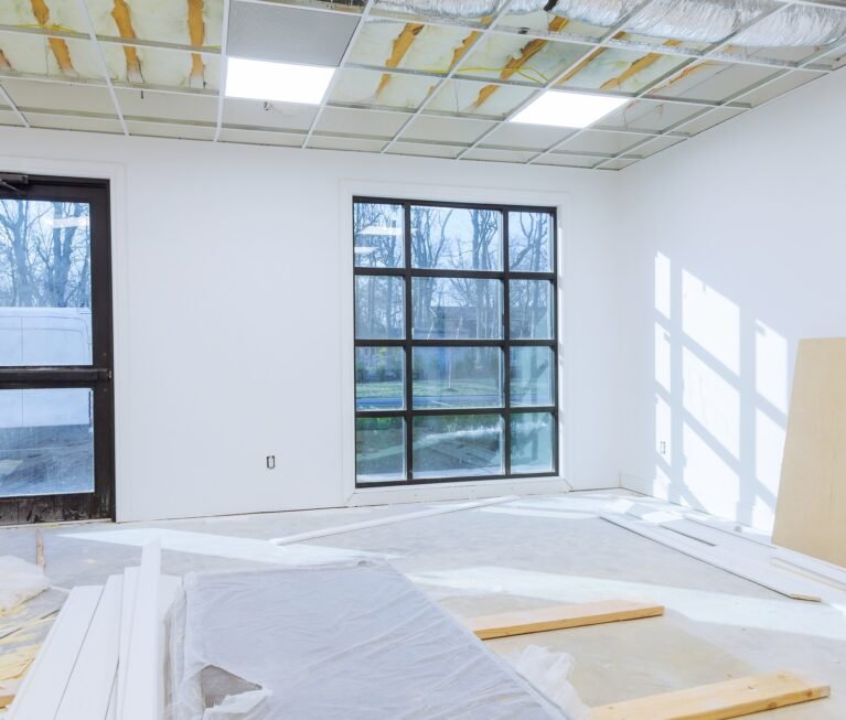 Making renovation of hung of suspended ceilings lights high in a bright modern office